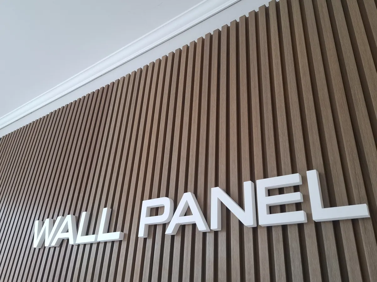 Pared revestida con Wall Panel de PVC en listones verticales color madera